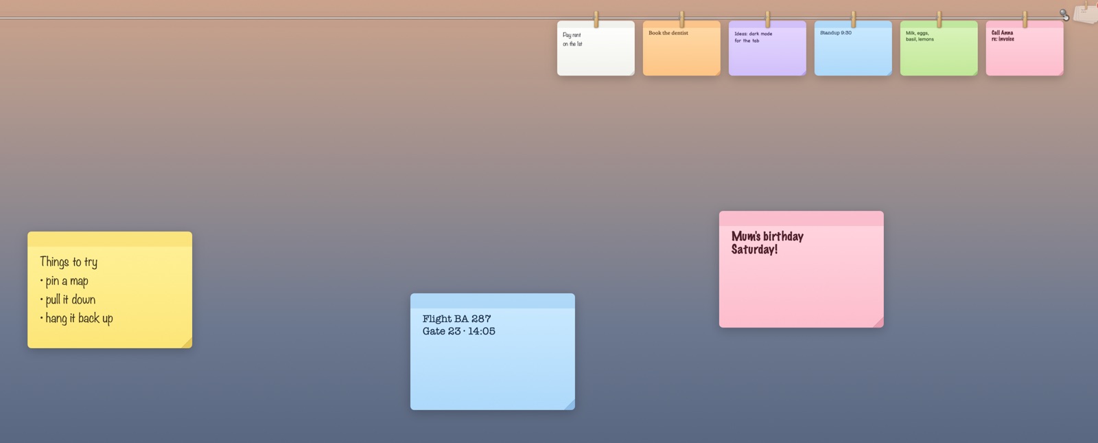 Sticky notes on the desktop, and more pegged on the line above, on yellow, blue, pink, white, orange, purple and green paper, each in a different hand.